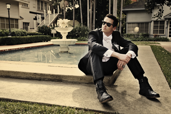 portrait of groom sitting on fountain edge wearing shades - wedding photo by top Orange County, California wedding photographers D. Park Photography